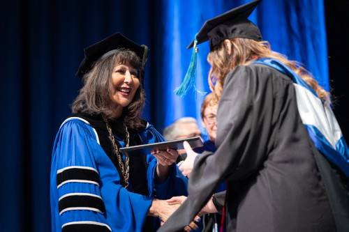 President Mantella with graduate student at commencement